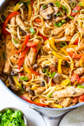 Overhead view of creamy Cajun pasta with chicken in a skillet.