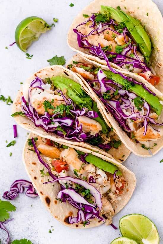 These easy Cilantro Lime Fish Tacos are made with flaky white fish, tomatoes, jalapeños, cilantro and lime topped with avocado. 