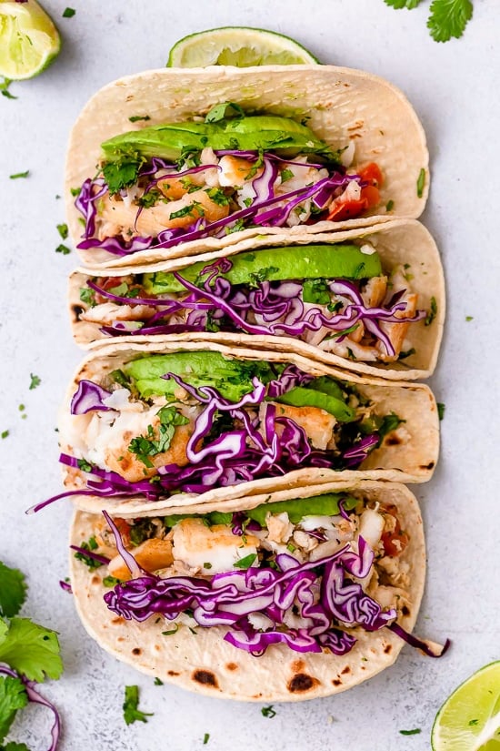 These easy Cilantro Lime Fish Tacos are made with flaky white fish, tomatoes, jalapeños, cilantro and lime topped with avocado.