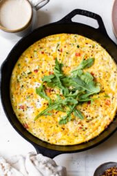 Caramelized onions and sautéed red bell peppers and zucchini mixed with eggs and Parmesan create a winning egg frittata breakfast dish.