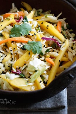 Light, fresh and crisp slaw made with shredded cabbage, carrots, lime juice, rice vinegar and a slightly under-ripe mango topped with sesame seeds. A perfect side to fish, pork and even burgers.