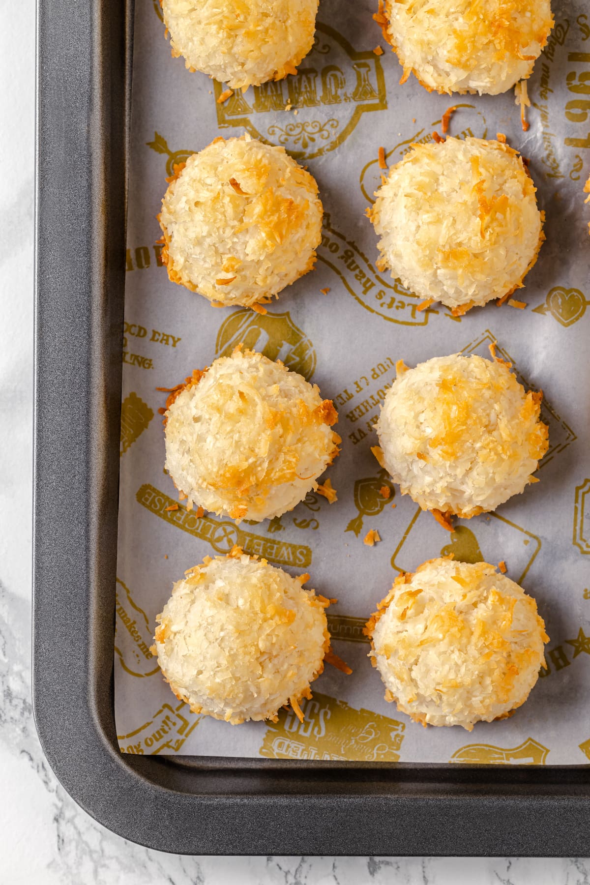 Six coconut macaroons on a baking sheet