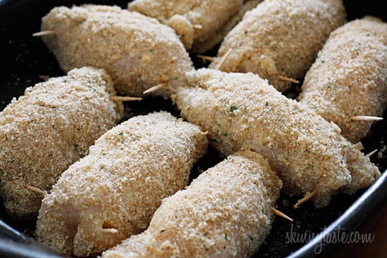 Chicken rolled with filling, prodded with toothpick and breaded.