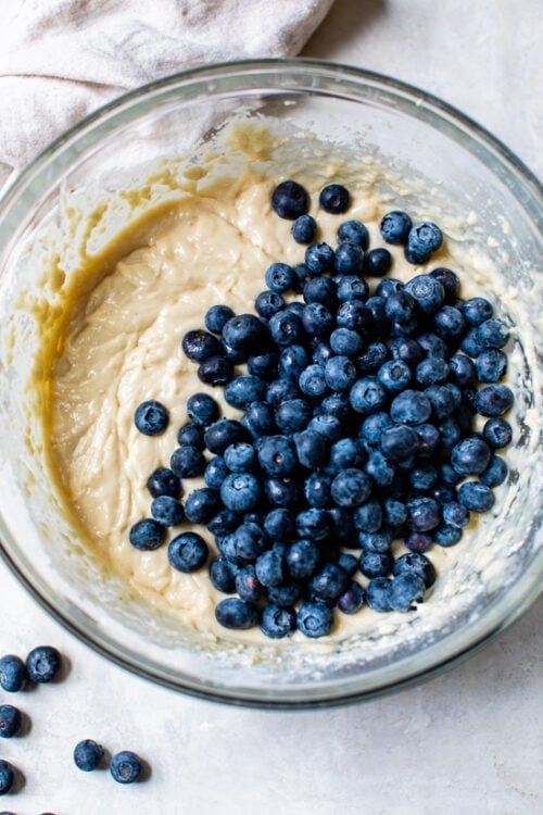 Cake batter in a bowl with blueberries