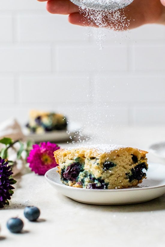 A piece of blueberry buttermilk cake on a plate.