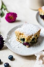 A slice of Blueberry Buttermilk Cake on a plate.