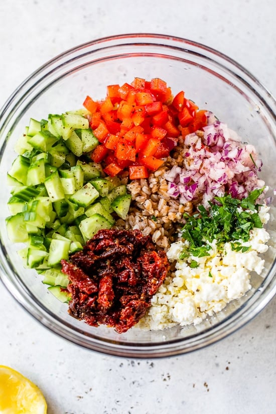 Farro, Feta, Cucumber and Dried Tomatoes in the bowl.