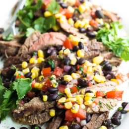 steak with tomatoes, corn and black beans