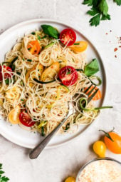 Angel hair pasta tossed with summer zucchini and tomatoes fresh from the garden. The perfect meatless meal you'll be craving again and again. Serve this with plenty of Parmigiano Reggiano!