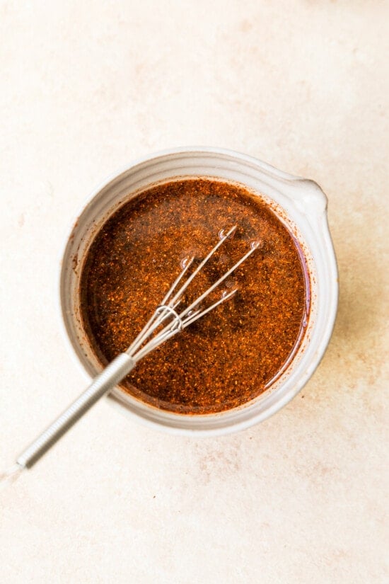 Overhead view of Pad Thai sauce in bowl with whisk