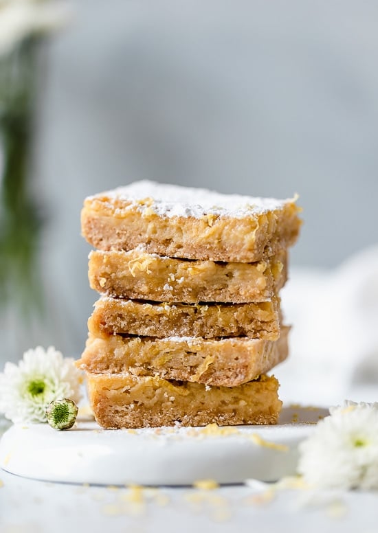Pucker Up! These sweet and tangy Honey Lemon Bars made with fresh lemon, lemon zest and honey and a whole wheat shortbread crust are a little lighter than traditional lemon bars, but are so tasty and hard to resist.