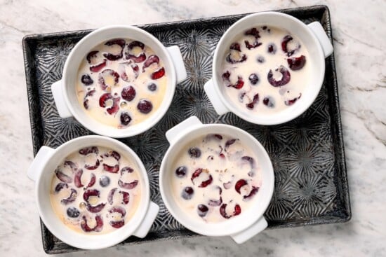 3 cherry clafoutis on pan before baking.