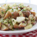 Apples add a sweet crunch to every bite of this lightened up potato salad.