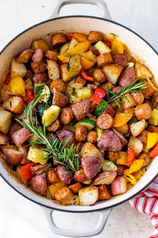one-pot skillet dinner made with chicken sausage, bell peppers, zucchini, baby red potatoes and fresh herbs.