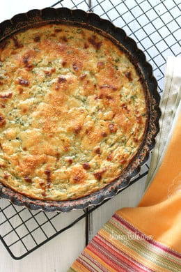 Crust-less Summer Zucchini Pie – a simple savory pie made with zucchini, shallots, mozzarella and parmesan cheese. If you're looking for a tasty way to use up your summer zucchini, this is it! This makes a wonderful side dish to any meal or serve it at a potluck or brunch.