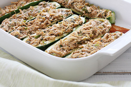 A fun twist on a Mexican favorite! Summer zucchini hollowed out and stuffed with shredded chicken, enchilada sauce, cheese and scallions. Serve this with cilantro lime rice and you'll have yourself a fiesta!