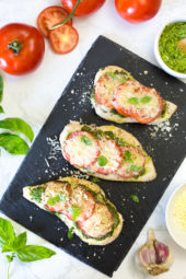 This easy Baked Pesto Chicken is a fast chicken dish made with skinless chicken breasts, pesto, tomatoes, mozzarella and Parmesan cheese. You can make this in the oven, or make it outside on the grill!