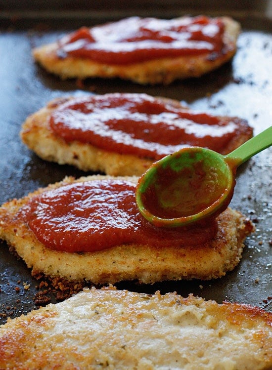 The Best Chicken Parmesan recipe, made a bit healthier! Breaded chicken cutlets are baked, not fried yet the chicken is so moist and full of flavor.