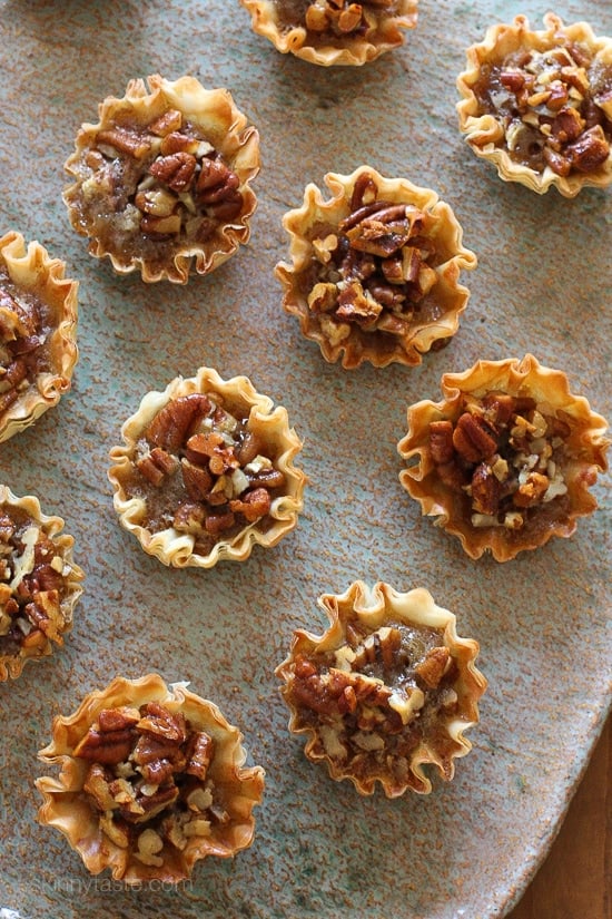 These bite sized pecan tarts are the perfect lighter alternative for pecan pie this holiday season! They are so easy to make, just 7 ingredients for a delicious treat.