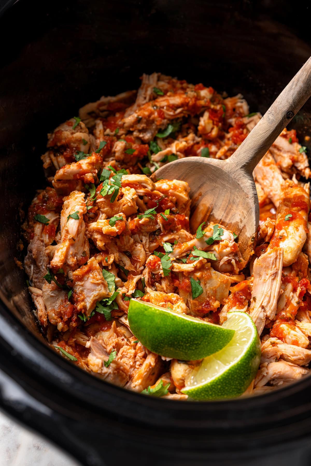 Salsa chicken inside the slow cooker.