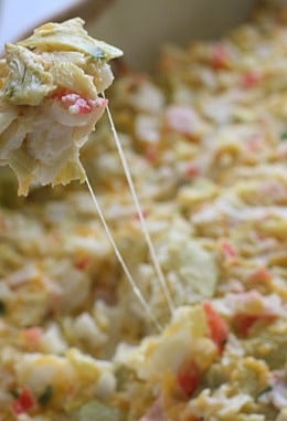 Hot and cheesy imitation crab and artichoke dip is to die for! Serve this glorious dip with baked chips and you will have the perfect appetizer for any party.