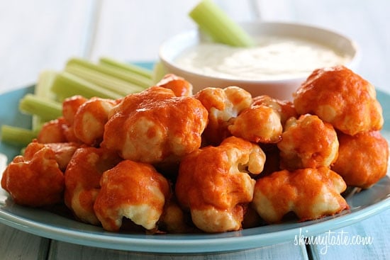 Hot and spicy cauliflower bites, battered and baked and smothered with hot sauce. Serve this with skinny blue cheese dressing and celery sticks on the side for a hot and spicy meatless appetizer.