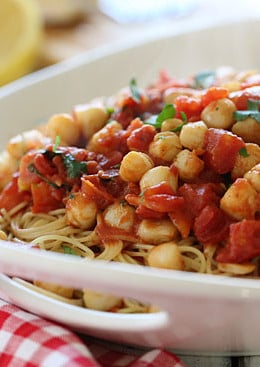 Sauteed bay scallops with tomatoes and a touch of white wine and lemon juice served over angel hair pasta.