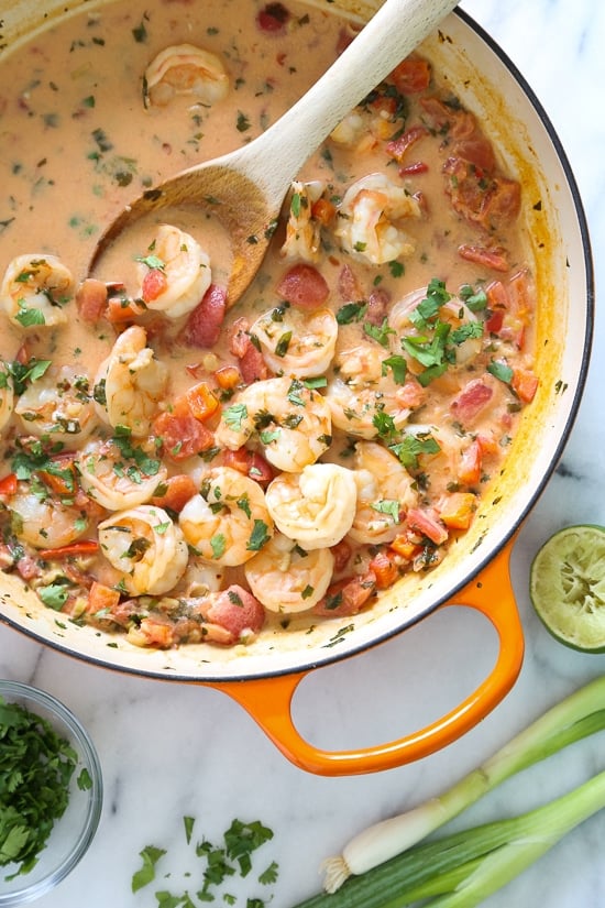 Garlic Shrimp in Coconut Milk, Tomatoes and Cilantro is a quick stew cooked in a light, tomato coconut broth with a hint of lime and cilantro. Simple enough to make for a weekday dinner yet sophisticated enough to serve to company. Serve with a little brown basmati rice to soak up the delicious broth.