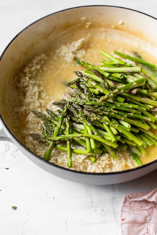 Creamy asparagus risotto, cooked with fresh herbs, Parmigiano-Reggiano and a touch of lemon. Perfect Spring meatless main dish or wonderful topped with grilled shrimp or scallops.
