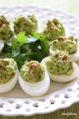 Guacamole Deviled Eggs make a healthy appetizer made with hard boiled eggs filled with mashed avocado, cilantro and lime juice.
