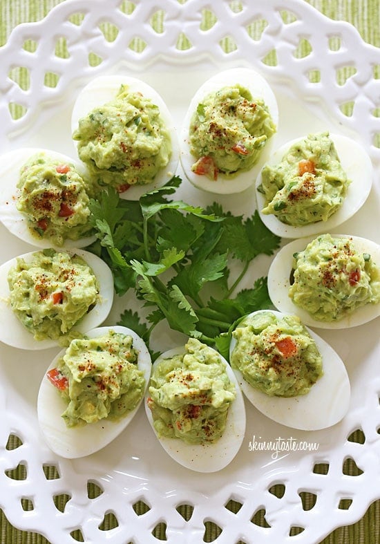 Guacamole Deviled Eggs make a healthy appetizer made with hard boiled eggs filled with mashed avocado, cilantro and lime juice.