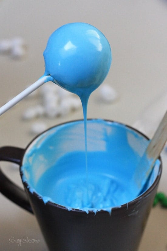Dipping the cake pops into melted chocolate.