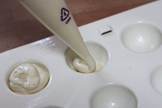 Piping the batter into the cake pop mold.