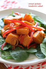 Kumara tandoori salad made of roasted sweet potatoes, seasoned with curry and spices, then tossed with bell peppers, baby spinach and a flavorful vinaigrette.