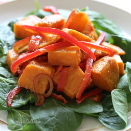 Kumara tandoori salad made of roasted sweet potatoes, seasoned with curry and spices, then tossed with bell peppers, baby spinach and a flavorful vinaigrette.