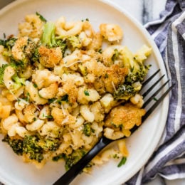 This easy, homemade, baked mac and cheese recipe adds broccoli to the mix, a great way to sneak veggies in a kid's favorite dish! It's also lightened up, so less calories than traditional mac and cheese.