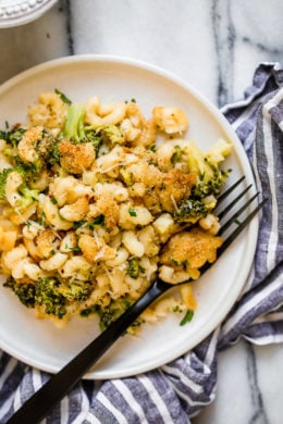 This easy, homemade, baked mac and cheese recipe adds broccoli to the mix, a great way to sneak veggies in a kid's favorite dish! It's also lightened up, so less calories than traditional mac and cheese.