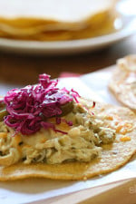 Chicken tenders are slow cooked in the crock pot with salsa verde, then served on a crispy corn tostada and topped with melted cheese, jalapeño and a simple cabbage slaw made with red cabbage, lime juice, cilantro and salt. I could eat these everyday!!