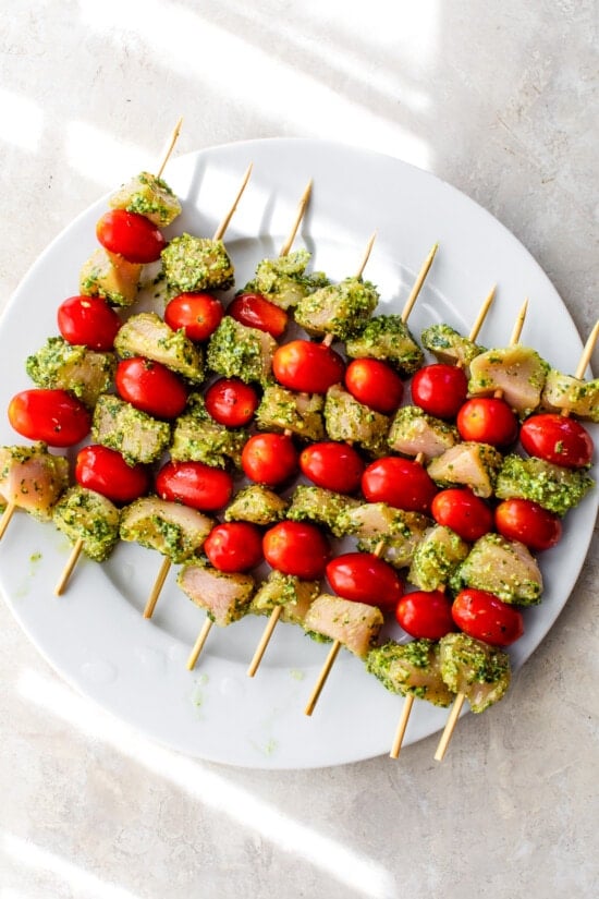 uncooked chicken and tomato skewers