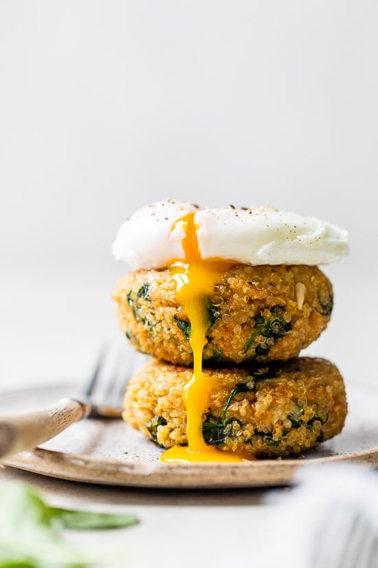 A quinoa and spinach patty topped with a poached egg.