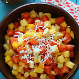 This tropical fruit salad, made with fresh papaya, mango, pineapple, bananas and grated coconut is the best tasting fruit salad... EVER!!
