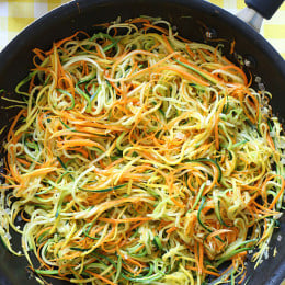 Zucchini, yellow squash and carrots cut into spaghetti like strands and sauteed with garlic and oil. I make this side dish ALL summer long – not just because it's low-carb, gluten-free, clean and paleo friendly, but because it's delicious, good for you and also happens to be my husband's favorite way to enjoy zucchini!
