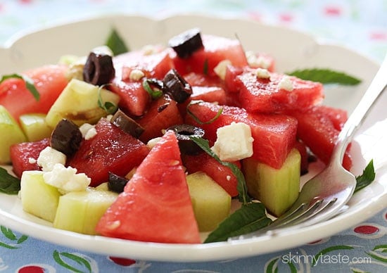 Salad with chilled watermelon and chunks of cucumber are tossed with feta cheese, Kalamata olives, fresh mint and a drizzle of balsamic glaze.