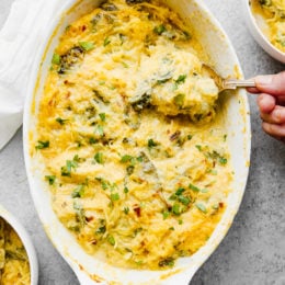 This easy, cheesy baked spaghetti squash is a healthier take on mac and cheese! It's cheesy, loaded with vegetables and feels like comfort food, without the calories and carbs.