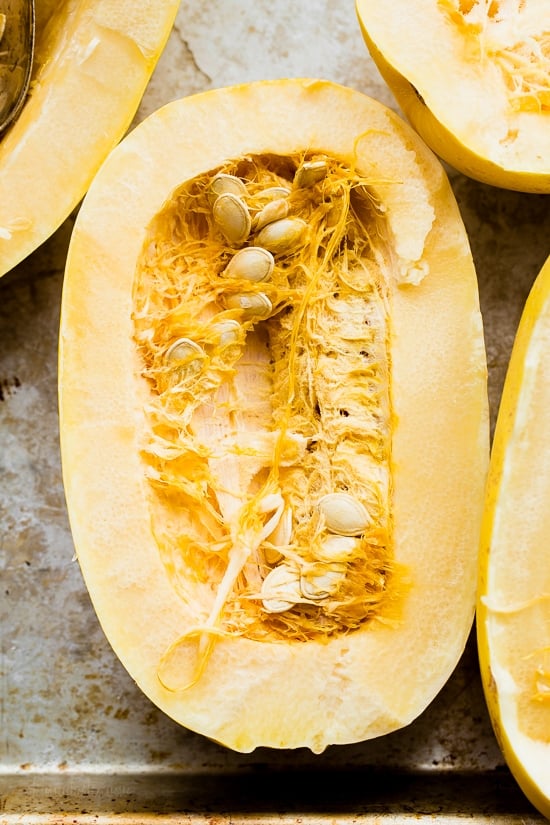 Half of an uncooked spaghetti squash with seeds