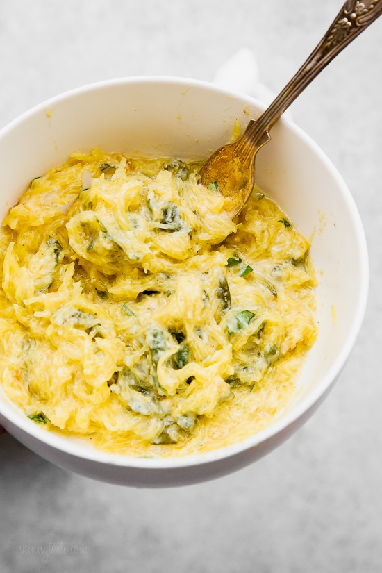 Bowl of cheesy baked spaghetti squash with green vegetables