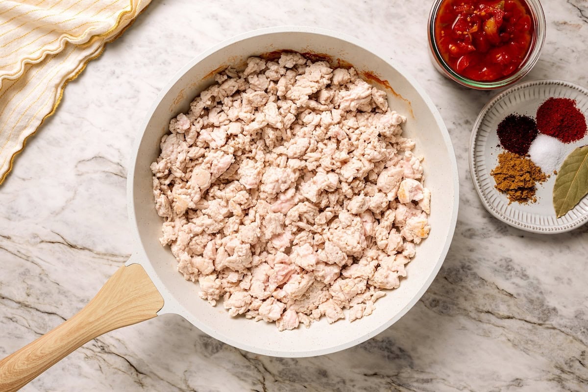 This crock pot turkey chili recipe is easy to make and family-friendly, with ground turkey, corn, bell pepper, tomatoes, and mild spices. Broken up and browned ground turkey in a skillet.