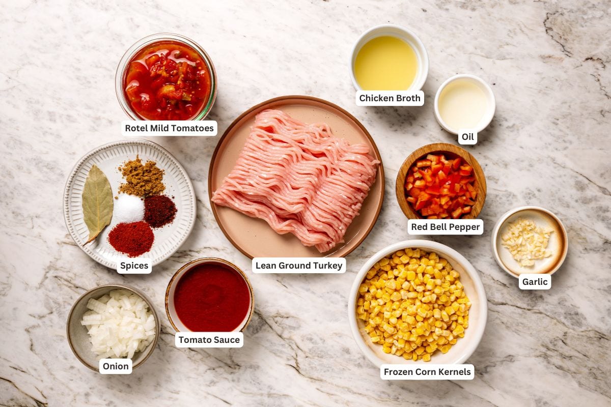 This crock pot turkey chili recipe is easy to make and family-friendly, with ground turkey, corn, bell pepper, tomatoes, and mild spices. Kid-friendly ingredients for crock pot turkey chili with text labels.
