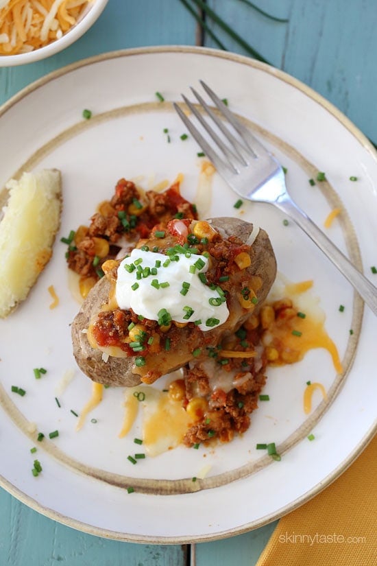 This loaded baked potato is stuffed with lean turkey chili, reduced fat shredded cheese and topped with some fresh chives – a quick, easy weeknight meal.