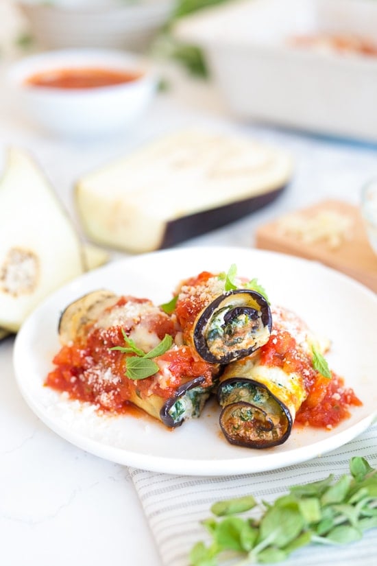 The best low-carb Eggplant Rollatini, made with thin slices of eggplant filled with a spinach and cheese ricotta filling, topped with marinara and mozzarella cheese. No frying, no breadcrumbs!